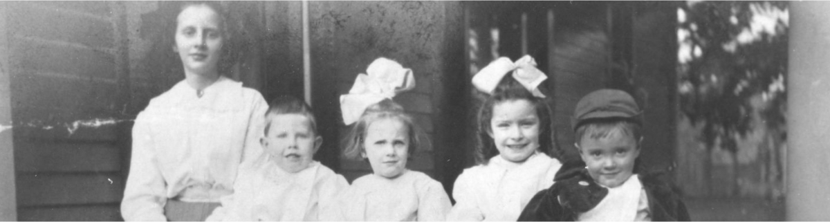 Early 1900's photograph of 5 children in black and white.